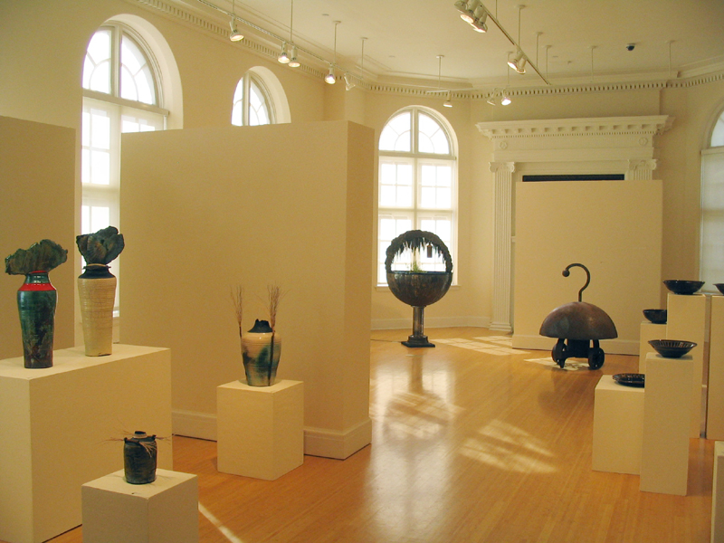Photo of ceramic and metal vessels in gallery