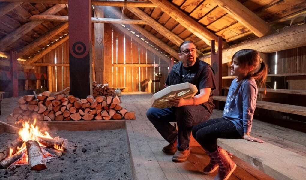 Chinook Indian Nation chairman Tony Johnson teaches a song to his daughter, Maybelle, as they warm up the longhouse with a wood burning fire,that they built in co-operation with the National Parks Service on the Ridgefield Wildlife Refuge
