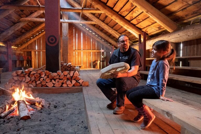 Chinook Indian Nation chairman Tony Johnson teaches a song to his daughter, Maybelle, as they warm up the longhouse with a wood burning fire,that they built in co-operation with the National Parks Service on the Ridgefield Wildlife Refuge